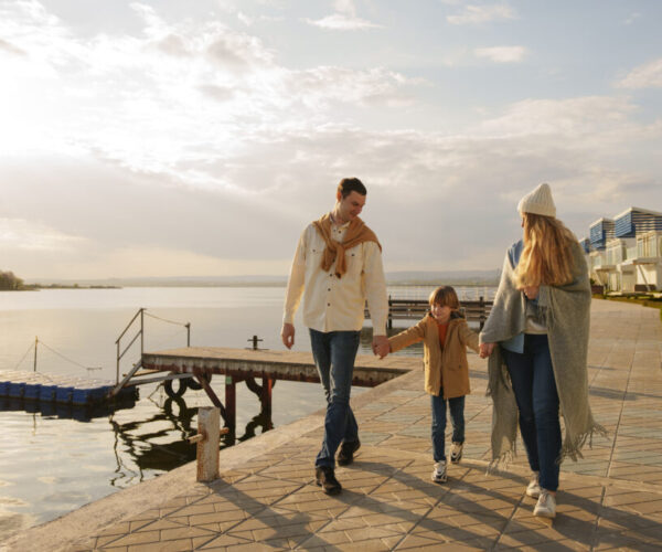 full-shot-family-hanging-out-jetty